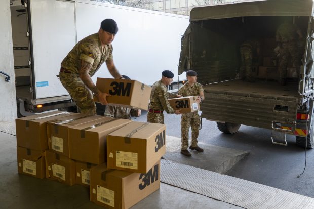 Soldiers from 4 Regiment, Royal Logistic Corps loading boxes into the back of a lorry