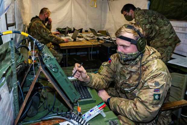 A Lance Corporal is seen here using the server to download incoming emails inside the main improvised command post which is behind a 4 tonne truck.