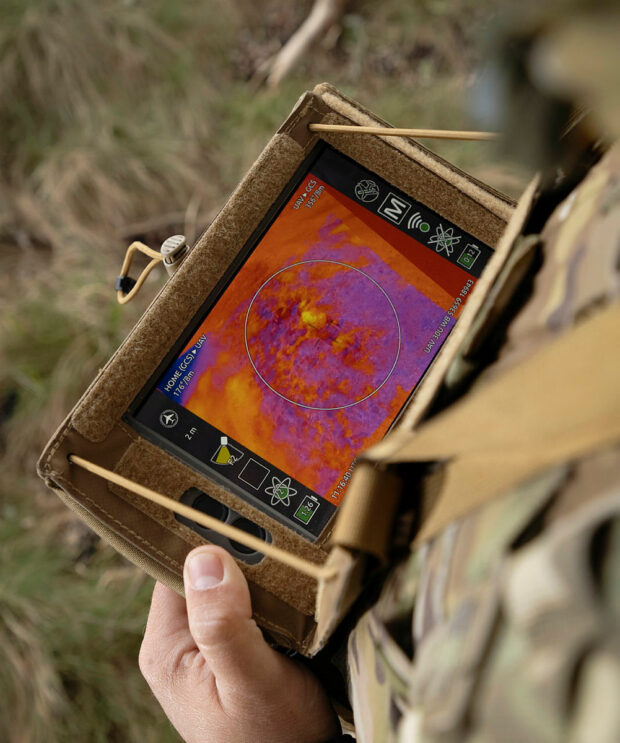 solider on the frontline looking at a computer display 